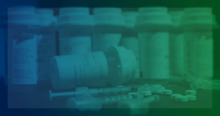 Needles, pills, and pill bottles on table