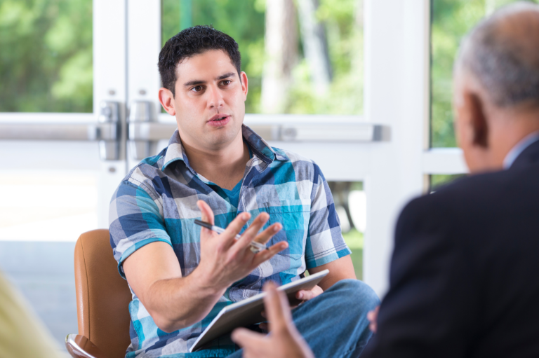Man talking to his Employer about Addiction Treatment